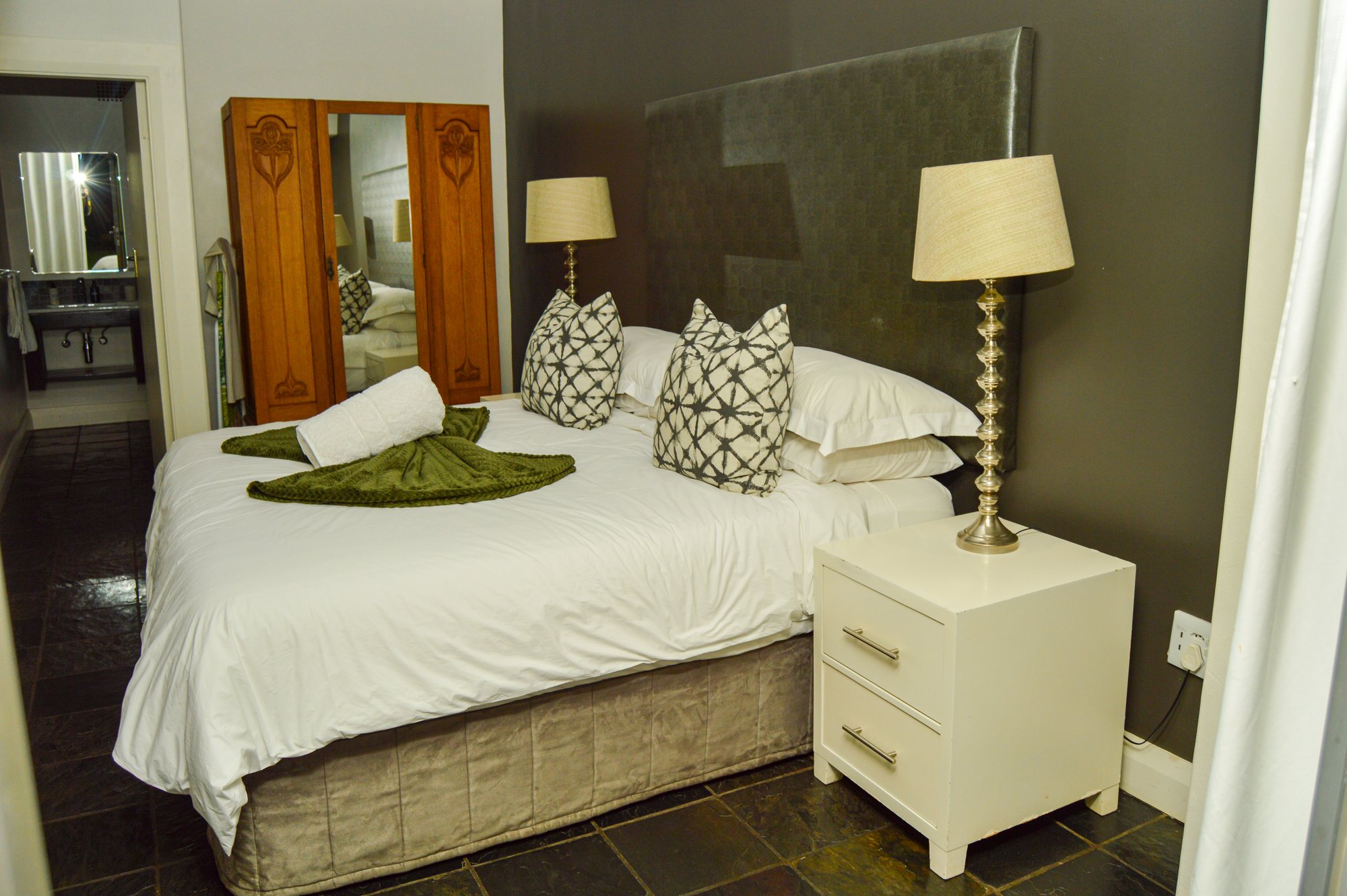 Room Two at Yellowwoods Bed & Breakfast with a panelled headboard and crisp white bedding