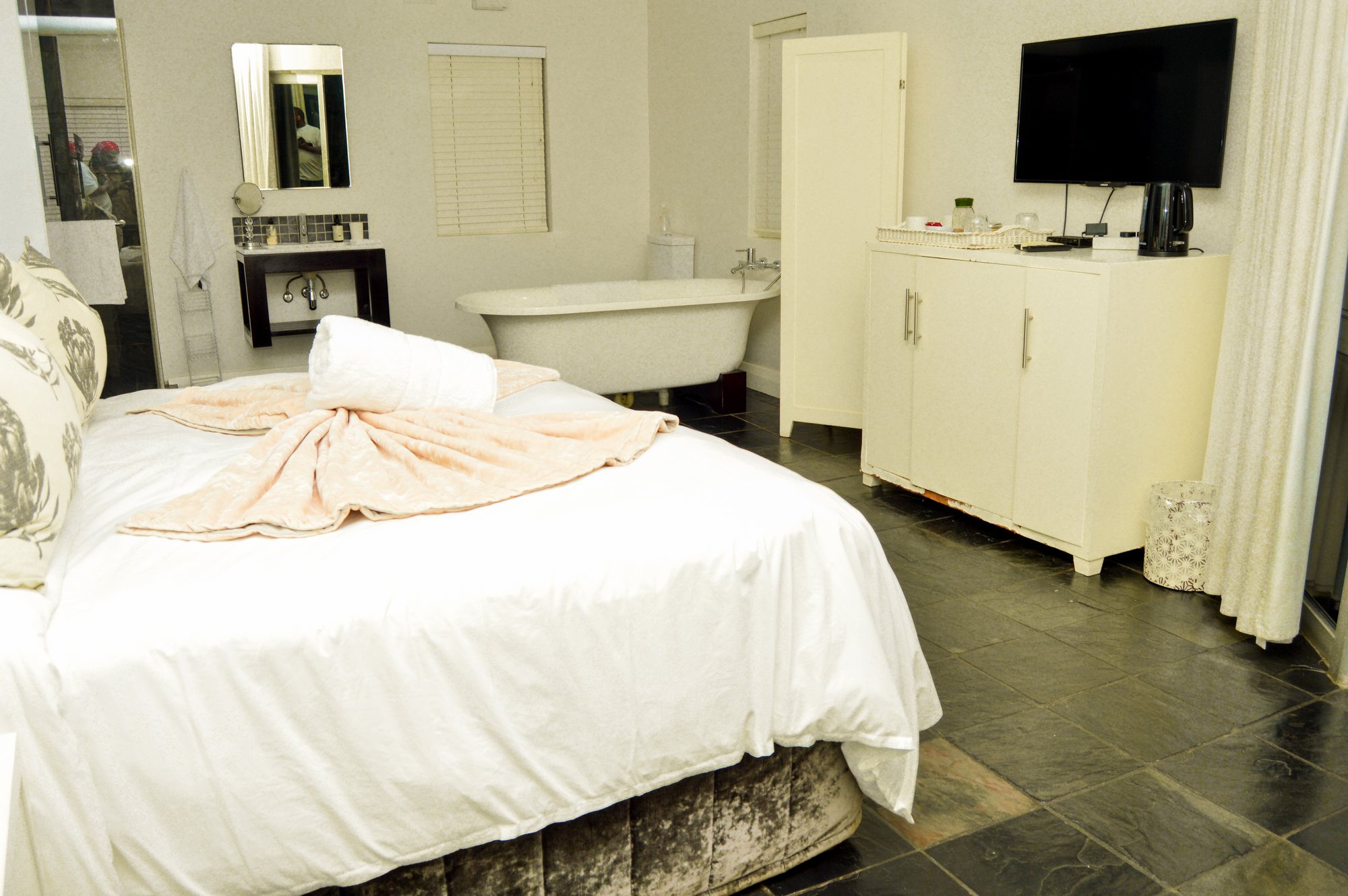 Room One at Yellowwoods Bed & Breakfast with white linen and a freestanding bath